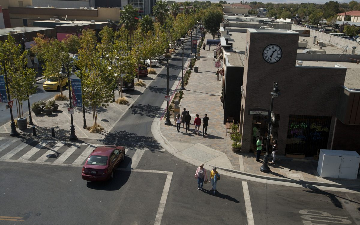 Aerial view of a tree-lined downtown street in Lancaster, CA