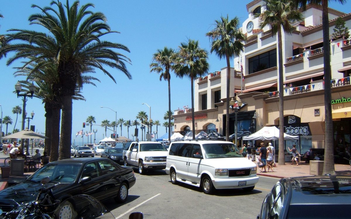 Palm trees and storefronts in downtown Huntington Beach, CA