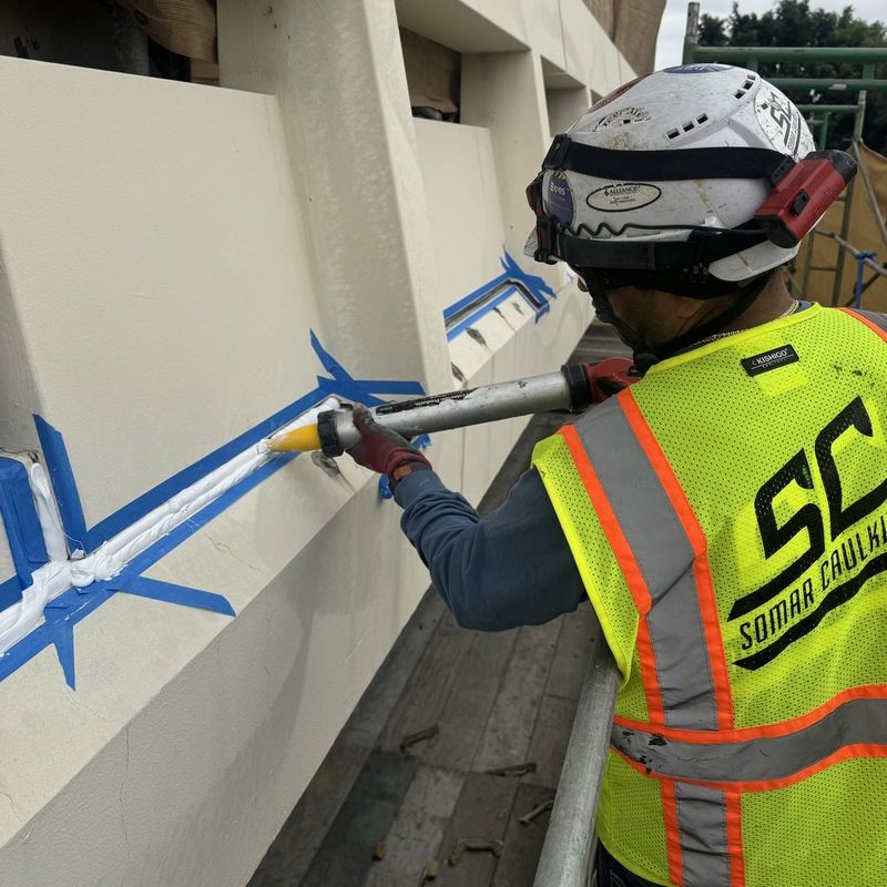 Somar Caulking crew member gunning sealant into a precast panel joint