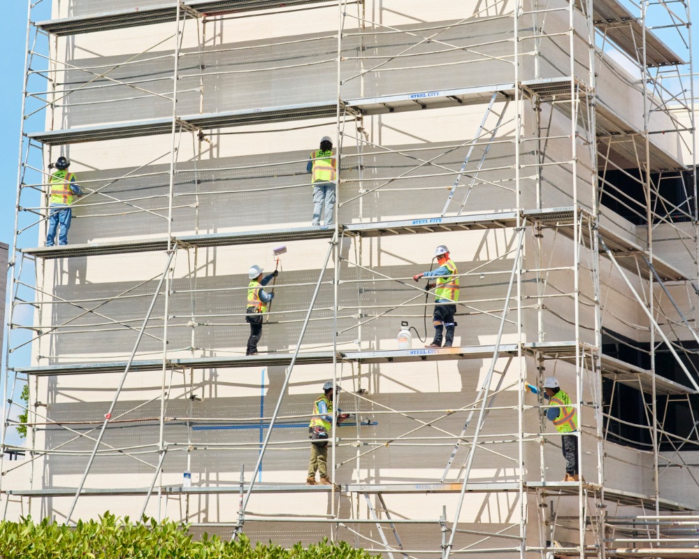 Somar Caulking crew working on scaffolding — commercial coating application