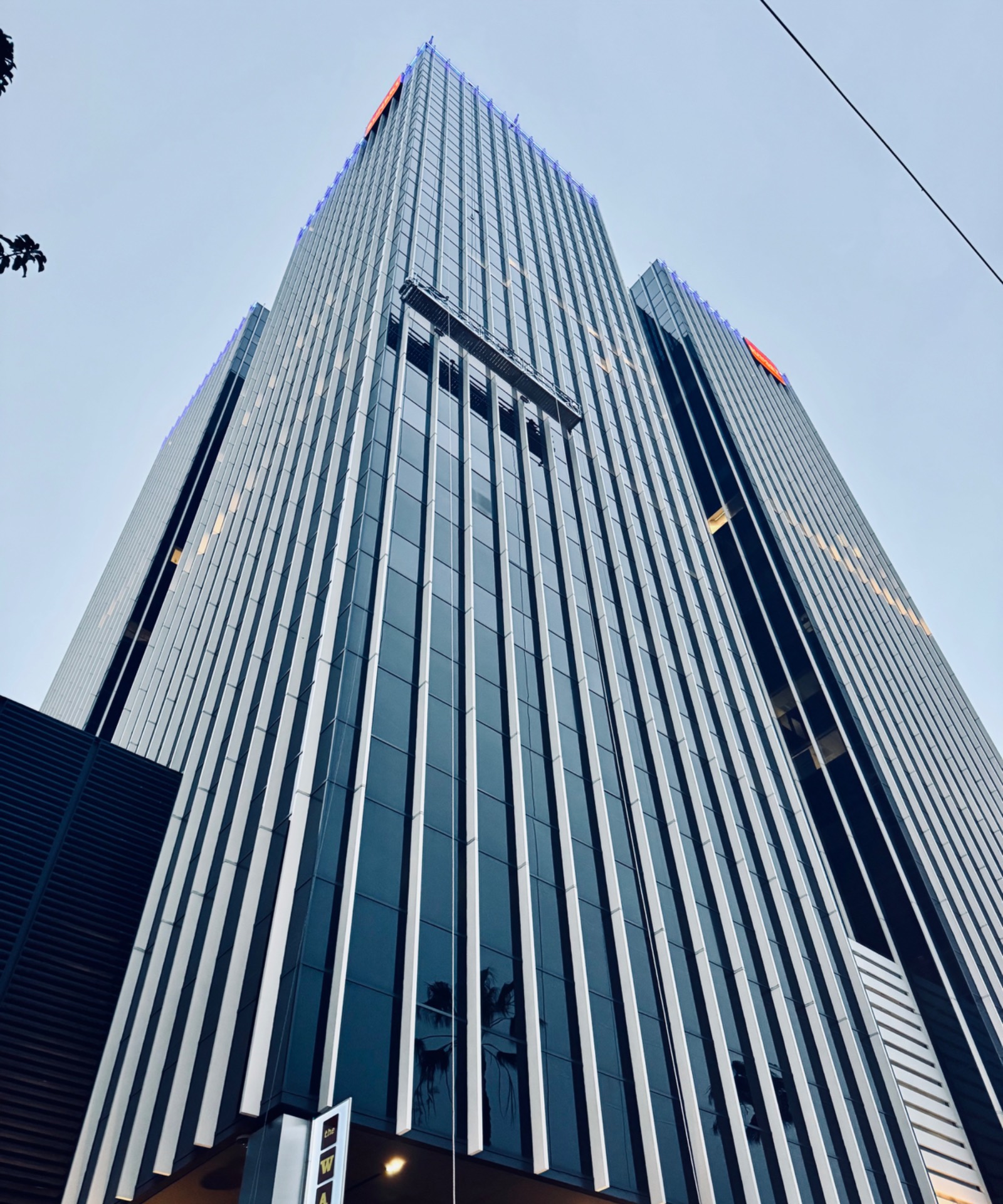 High-rise tower from below with swing stage at the top — Long Beach, California